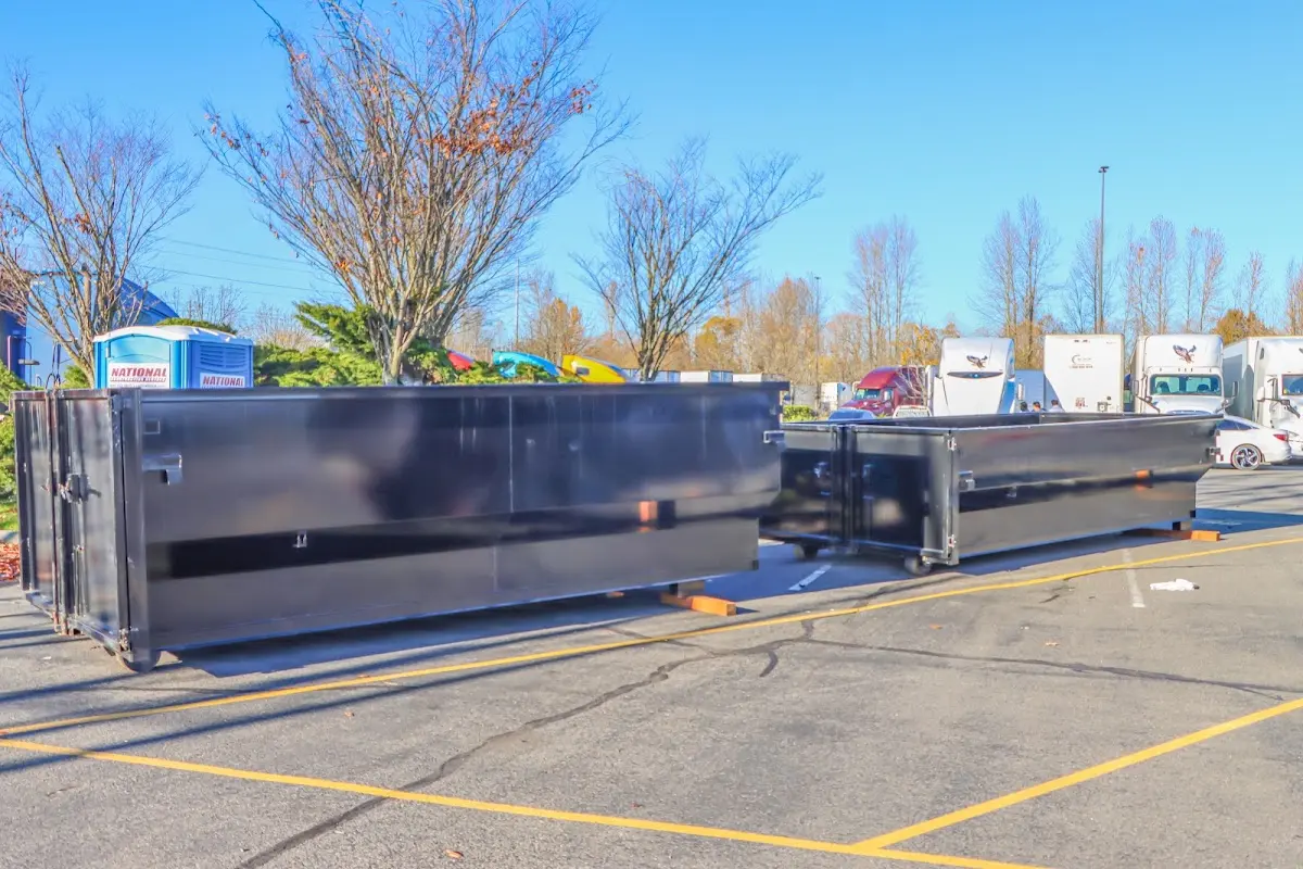 Professional dumpster rental service with roll-off container on residential driveway in Milwaukie